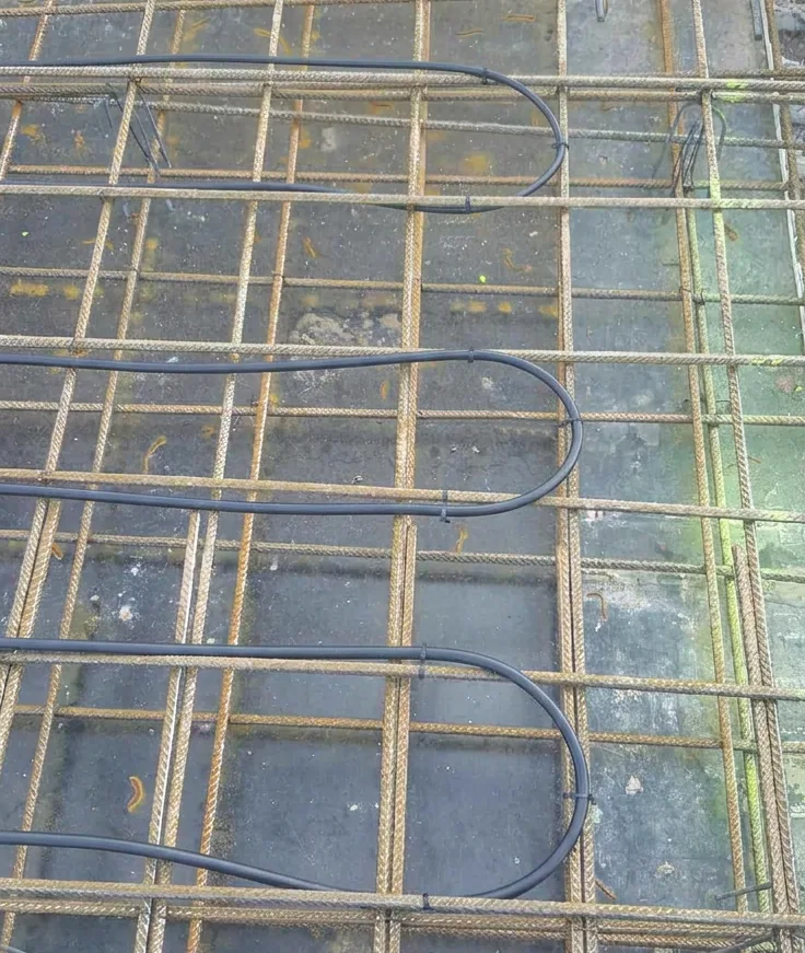 Cable tied to the reinforcing mesh of a ground floor slab, with a tie at each crossing.