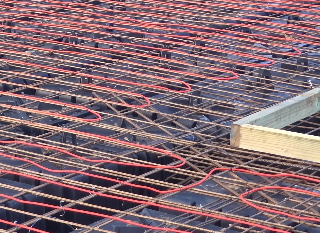 Frost heave heating cable run across the reinforcement over the sub base of a cold store floor, before the pour.
