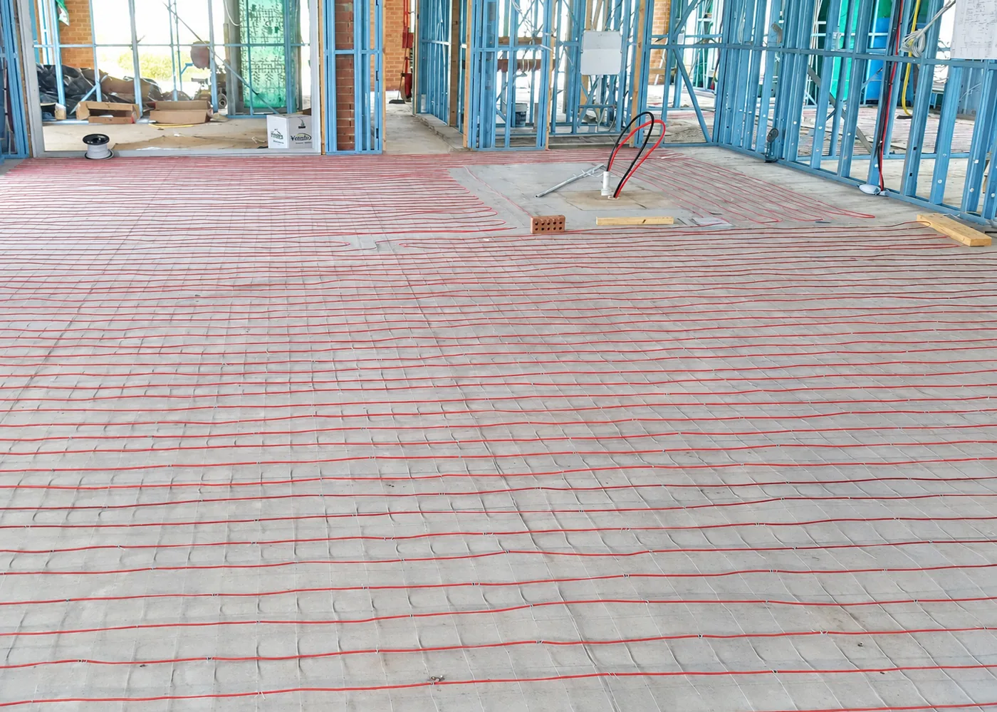 Cable run across a large commercial floor, with the steel wall framing up and the screed still to go on.
